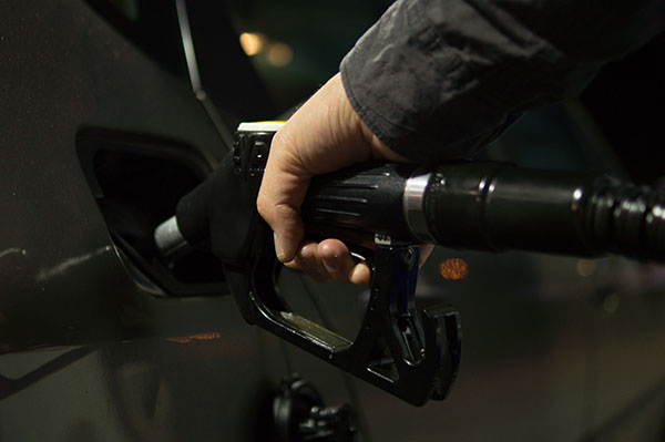 Man's hand filling up a car with fuel. Source: Pexels
